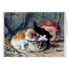 Two kittens having tea party