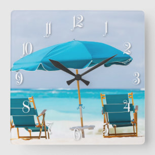 Two lounges on the ocean beach square wall clock