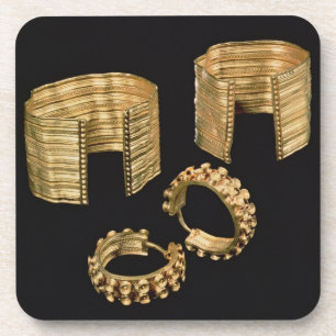Two open facetted bracelets and a pair of earrings coaster