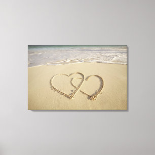 Two overlying hearts drawn on the beach canvas print