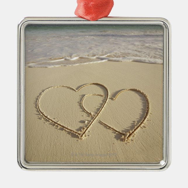 Two overlying hearts drawn on the beach metal ornament (Front)