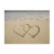 Two overlying hearts drawn on the beach
