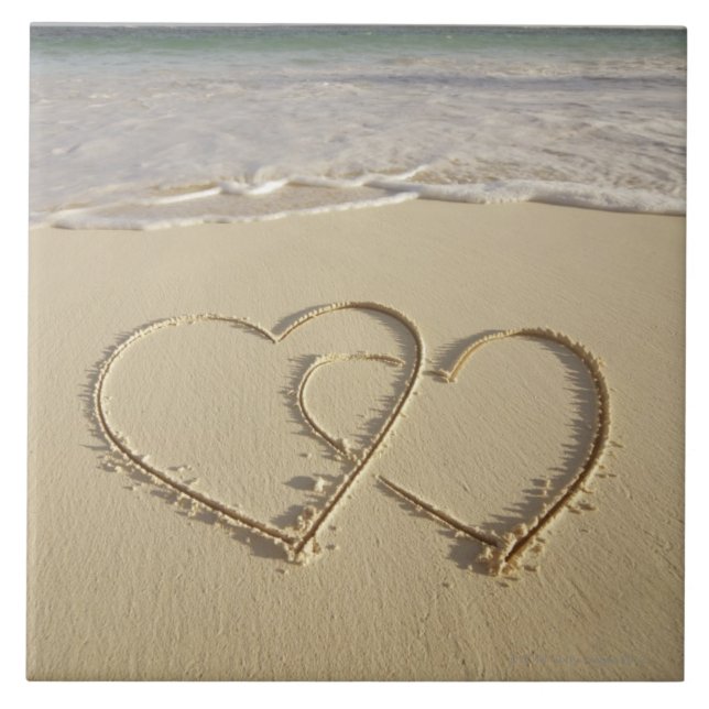 Two overlying hearts drawn on the beach with tile (Front)