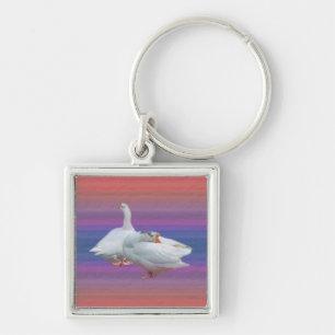 two playful white geese keychain