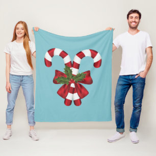 Two Red And White Festive Candy Canes On Blue Fleece Blanket