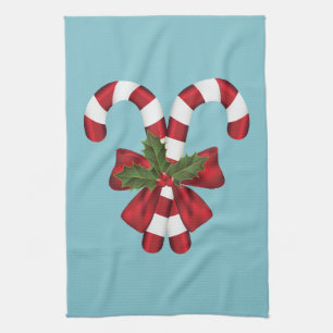 Two Red And White Festive Candy Canes On Blue Kitchen Towel
