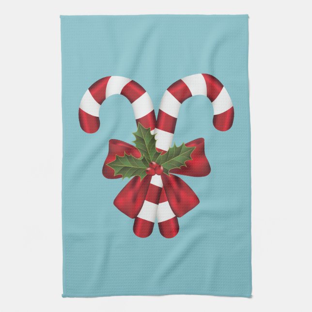 Two Red And White Festive Candy Canes On Blue Kitchen Towel (Vertical)