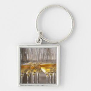 two rows of wine tasting glasses with lucious keychain