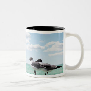Two seagulls sitting on a dead tree sticking out Two-Tone coffee mug