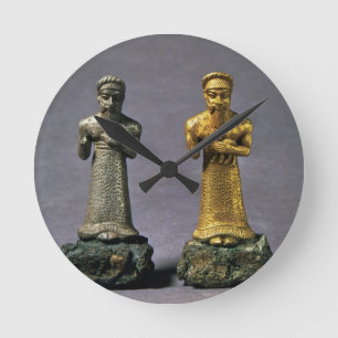 Two statuettes of men carrying offerings of goats, round clock