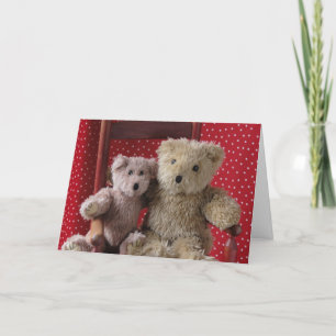 two teddy bears in a red chair greeting card