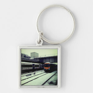 Two trains, in the snow keychain