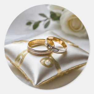 Two wedding rings on a white pillow classic round sticker
