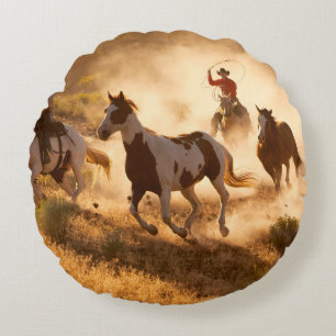 Two western cowboys riding horses, roping wild hor round pillow