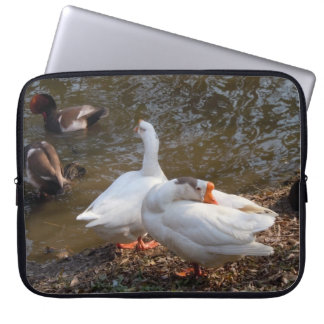 two wild white geese playing by a pond laptop sleeve