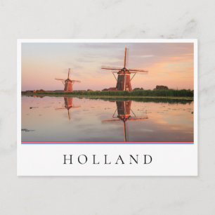 Two windmills with reflection at sunset postcard