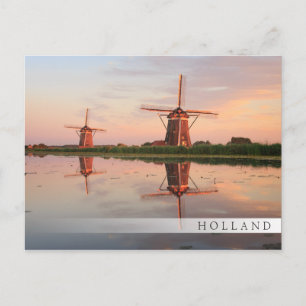 Two windmills with reflection at sunset postcard
