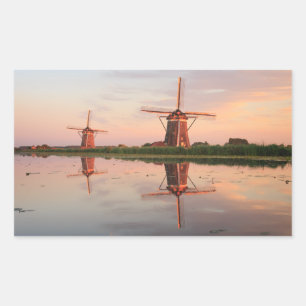 Two windmills with reflection at sunset sticker