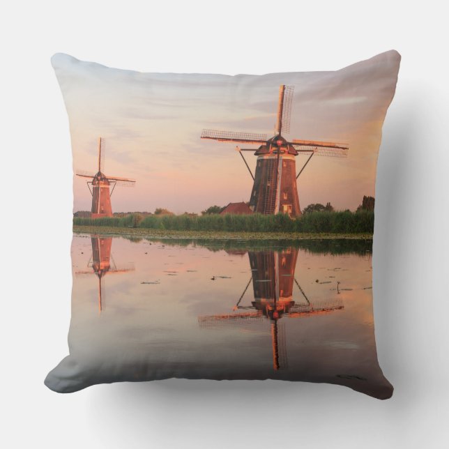 Two windmills with reflection at sunset throw pillow (Front)