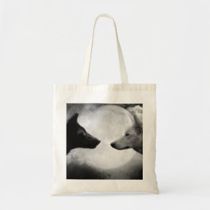 Two wolves facing each other tote bag