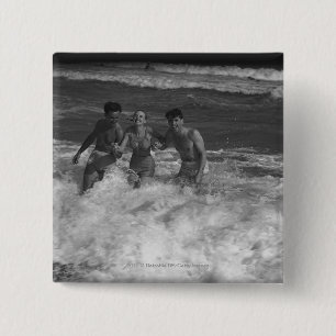 Two young men and woman playing in wave B&W 2 Inch Square Button