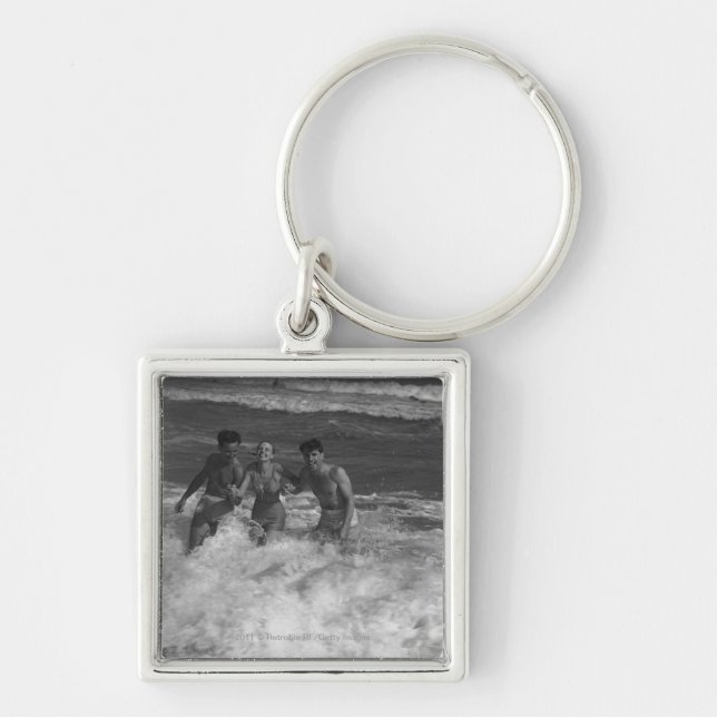 Two young men and woman playing in wave B&W Keychain (Front)