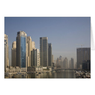 UAE, Dubai. Marina towers with boats at anchor.