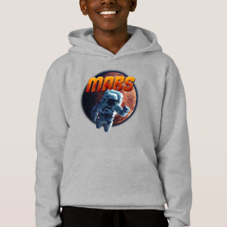 Un astronaute devant la planète Mars.