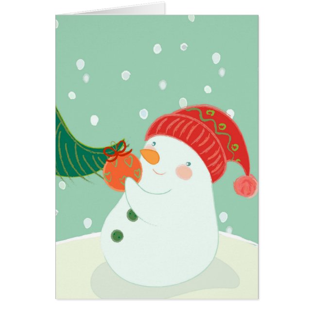 Un bonhomme de neige accrochant un ornement sur un (Devant)