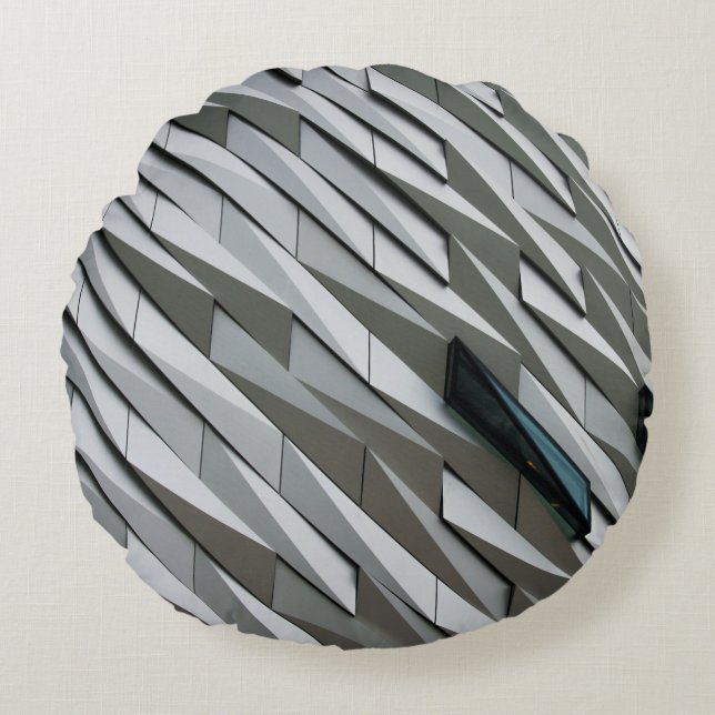 Undulating abstract shapes on a building facade at round pillow (Front)
