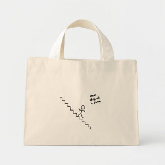 "une marche à la fois", bâton homme sur le sac d'e