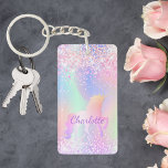 Unicorn pink purple name holographic keychain<br><div class="desc">A trendy holographic background with unicorn and pastel colours in pink,  purple,  mint green. Decorated with faux glitter. Personalize and add your name.  Purple coloured letters.  A bit of everyday glam to brighten up your day!</div>