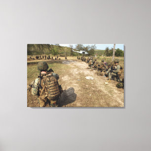 US Marines provide security as a UH-1N Canvas Print