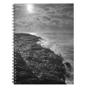 USA. Molten lava flows into the ocean at sunrise Notebook
