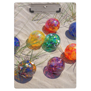 USA, Oregon. Colourful Glass Floats On Sand Dune Clipboard
