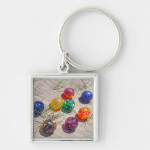 USA, Oregon. Colourful Glass Floats On Sand Dune Keychain