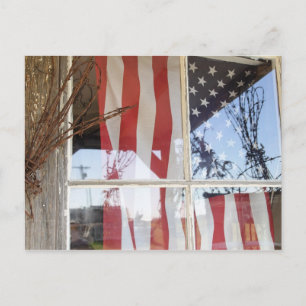 USA, Oregon, Shaniko. Flag in window next to Postcard