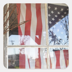USA, Oregon, Shaniko. Flag in window next to Square Sticker