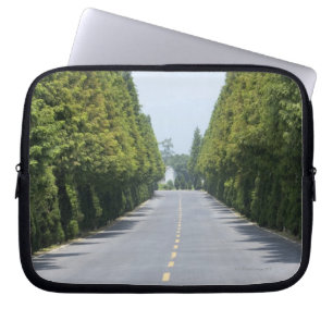 USA, Yellowstone National Park, Treelined road Laptop Sleeve