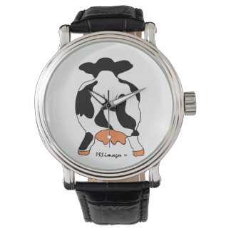 Vache noire et blanche derrière la montre