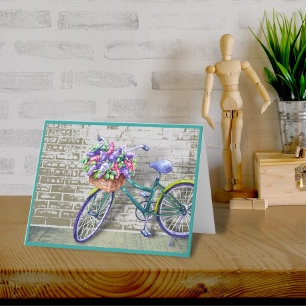 Vélo avec carte de note du panier à fleurs
