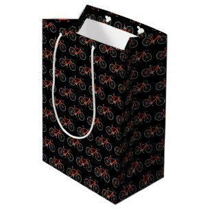 Vélo orange sur sac cadeau moyen noir