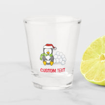 Pingouin de Noël assis avec des boules de neige