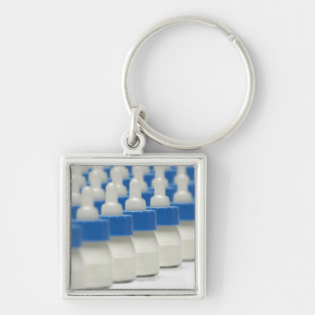 Very small feeding bottles in perspective, shot keychain (Front)