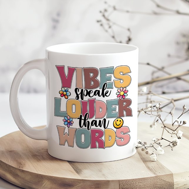 "Vibes Speak Louder Than Words" Hippie Colourful Coffee Mug ("Vibes Speak Louder Than Words" Hippie Colorful Coffee Mug on a boho table with tiny dry flowers)