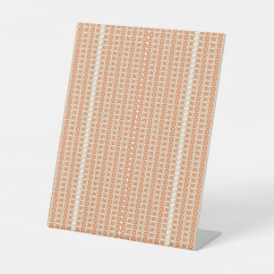 Vibrant Orange and White Striped Background with Pedestal Sign