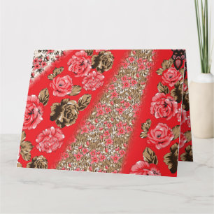 Vibrant red fabric featuring intricate floral and card