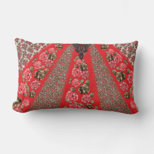 Vibrant red fabric featuring intricate floral and  lumbar pillow