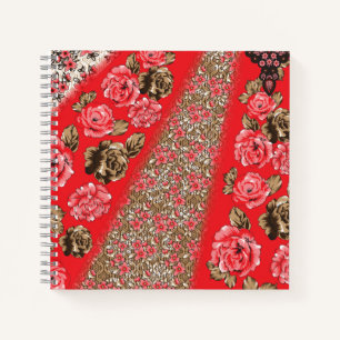 Vibrant red fabric featuring intricate floral and notebook