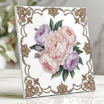 Victorian Peony Bouquet with Gold Scrollwork Tile<br><div class="desc">This exquisite Victorian-inspired ceramic design features a delicate bouquet of pink and lavender peonies at its centre, surrounded by intricate golden scrollwork on a crisp white background. The floral arrangement radiates timeless elegance, perfect for adding a touch of luxury to kitchens, bathrooms, or decorative accents. The ornate detailing and soft...</div>